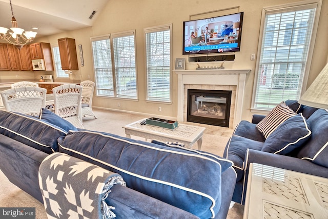 living room featuring lofted ceiling, carpet flooring, and a healthy amount of sunlight