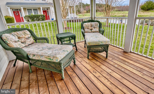 wooden terrace featuring a lawn