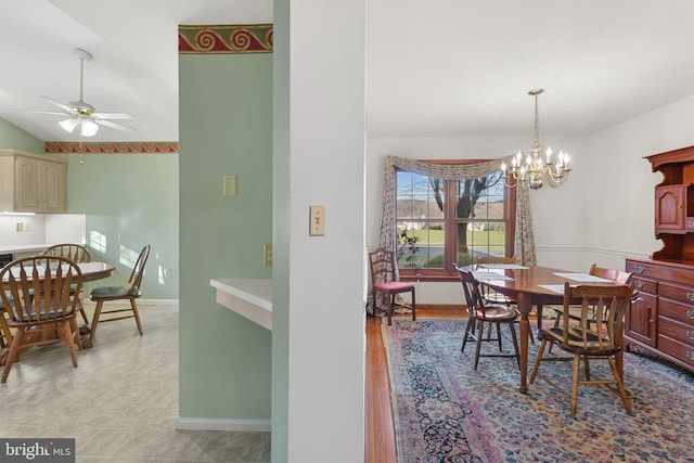 dining area featuring ceiling fan with notable chandelier and light hardwood / wood-style flooring