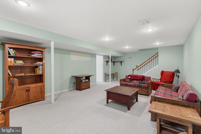 living room featuring light colored carpet and a wall mounted air conditioner