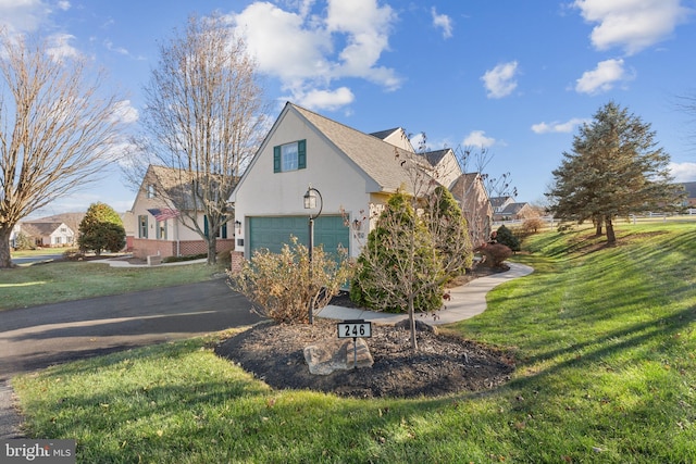 view of home's exterior with a garage and a lawn