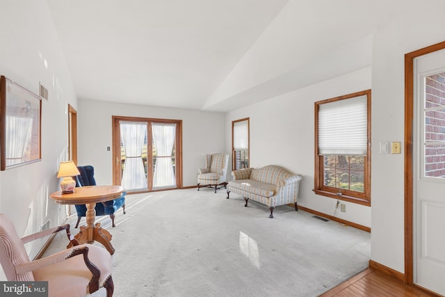 sitting room featuring lofted ceiling and hardwood / wood-style flooring