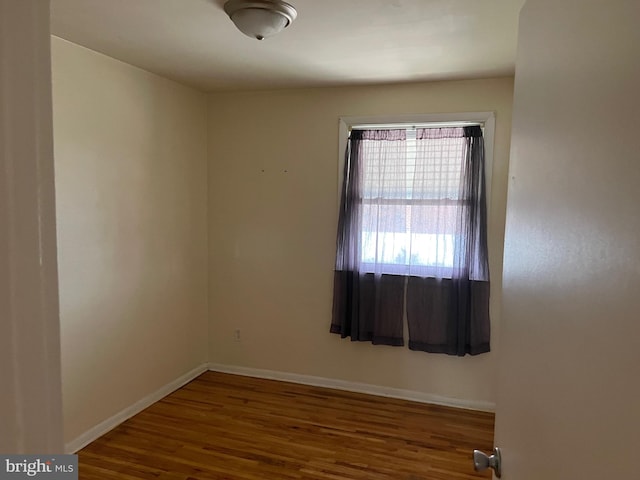 empty room with wood-type flooring