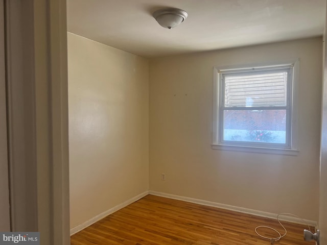 spare room featuring wood-type flooring