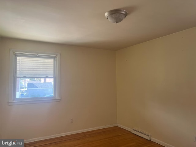 empty room with hardwood / wood-style flooring