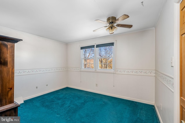 carpeted empty room with ceiling fan and crown molding