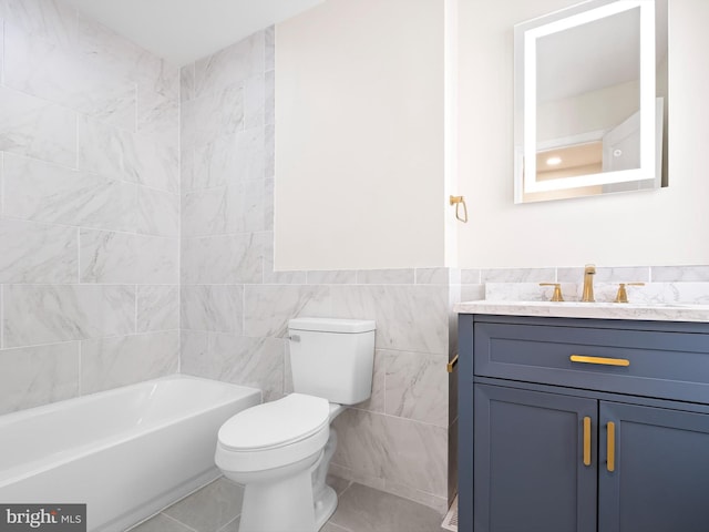 bathroom featuring vanity, toilet, tile patterned floors, and tile walls