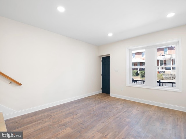 empty room with hardwood / wood-style floors