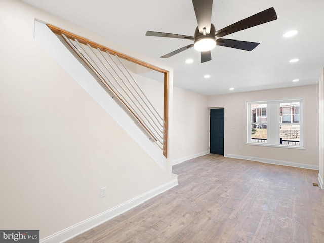 empty room with light hardwood / wood-style flooring and ceiling fan