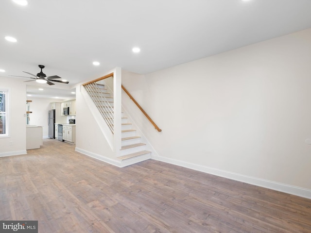 unfurnished living room with hardwood / wood-style floors and ceiling fan