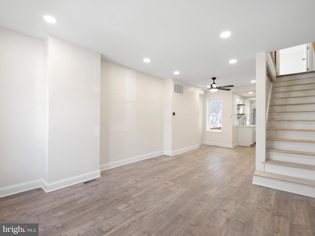 interior space featuring hardwood / wood-style floors, sink, and ceiling fan