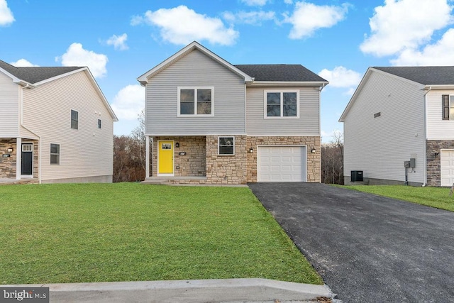 view of front of house with a garage and a front lawn