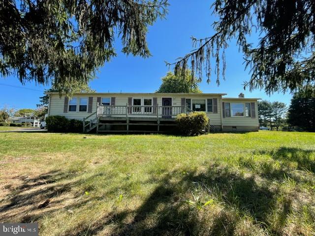 view of front facade with a front yard and a deck