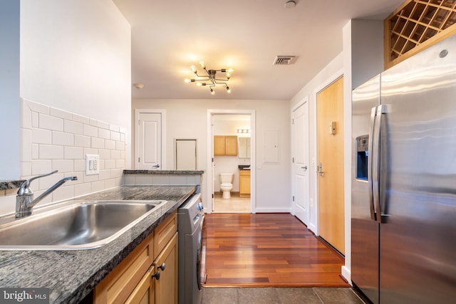 kitchen featuring stainless steel appliances, dark wood-type flooring, sink, and decorative backsplash