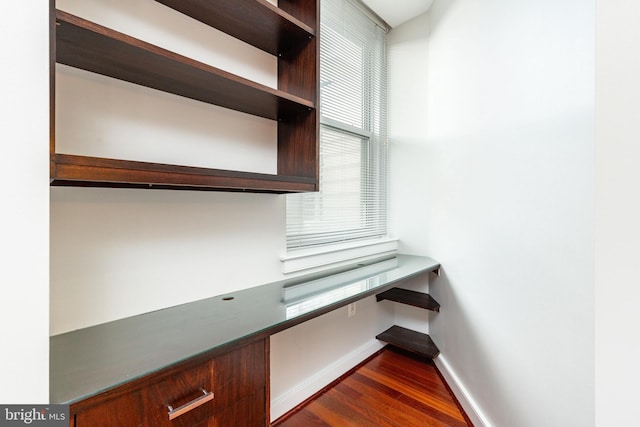 unfurnished office featuring dark hardwood / wood-style flooring