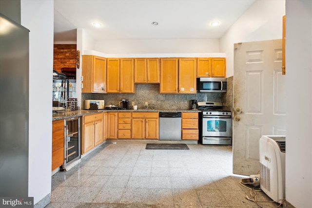 kitchen with decorative backsplash, wine cooler, appliances with stainless steel finishes, dark stone countertops, and sink