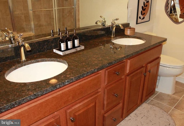 bathroom featuring tile patterned flooring, vanity, and toilet