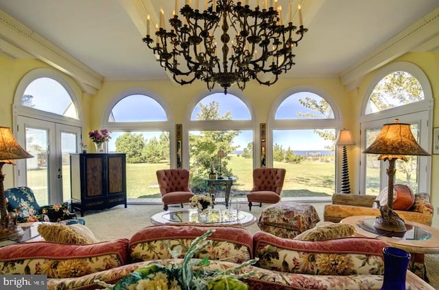 living room featuring ornamental molding, french doors, and an inviting chandelier