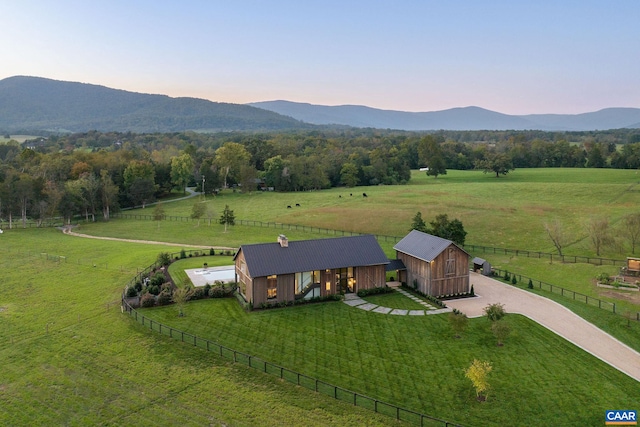 aerial view at dusk with a rural view and a mountain view