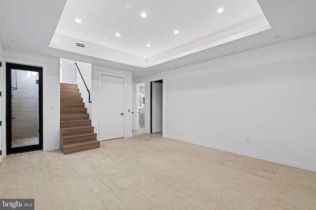 unfurnished room featuring a raised ceiling