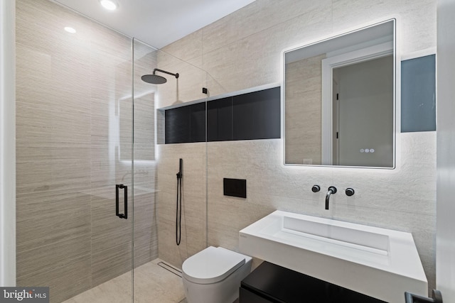 bathroom featuring a shower with door, toilet, tile walls, and vanity