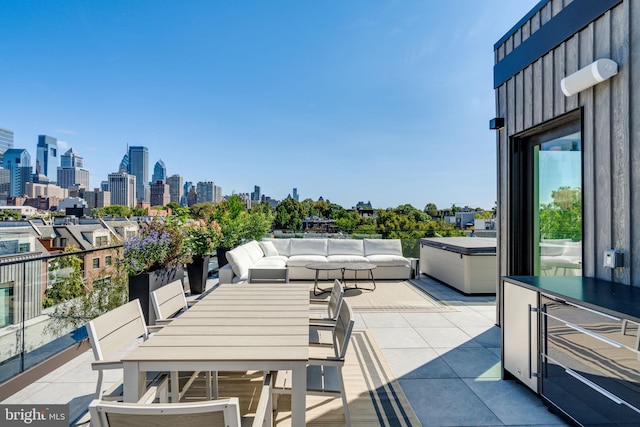 view of patio / terrace with wine cooler, a balcony, and outdoor lounge area