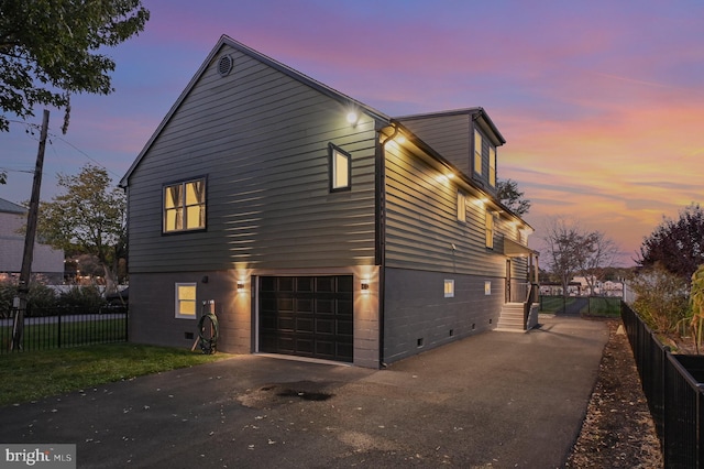 property exterior at dusk with a garage