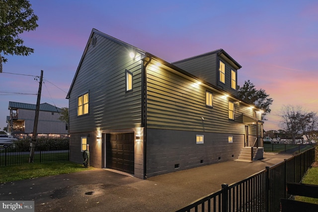 property exterior at dusk featuring a garage