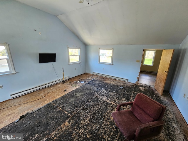 living room featuring lofted ceiling, plenty of natural light, and baseboard heating