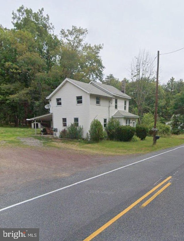 view of property exterior with a carport