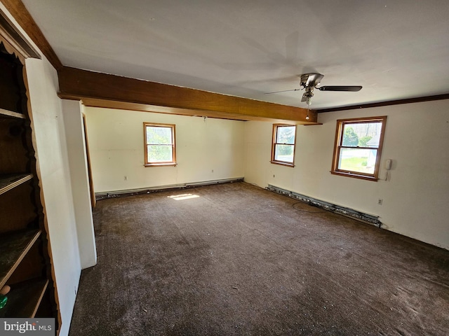 carpeted spare room with a healthy amount of sunlight, ceiling fan, crown molding, and baseboard heating