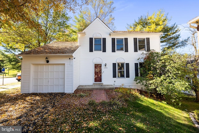 view of front of property with a front lawn and a garage