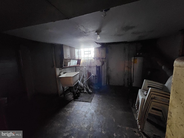 basement featuring water heater and sink