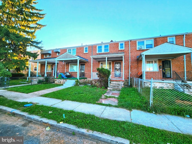 view of property with a front yard and covered porch