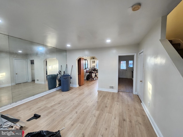 workout area with light hardwood / wood-style floors