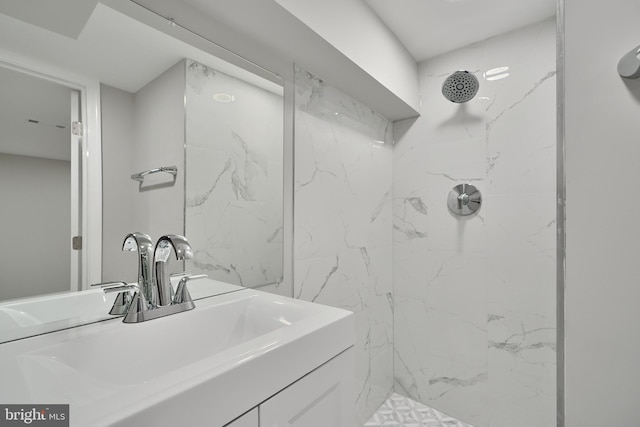 bathroom with vanity and a tile shower