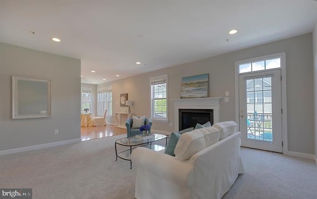 living room with plenty of natural light and light carpet