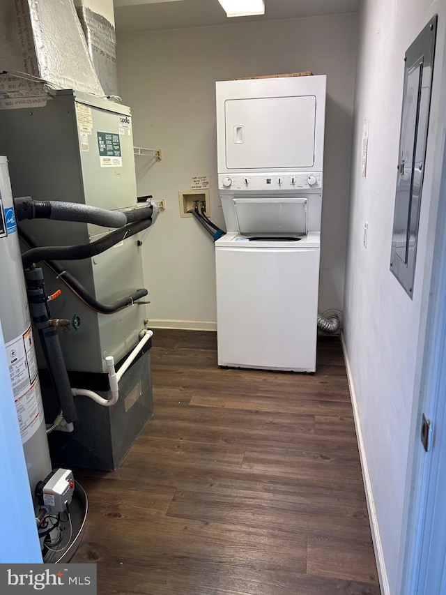 laundry room featuring stacked washer / drying machine, dark wood-type flooring, and heating unit