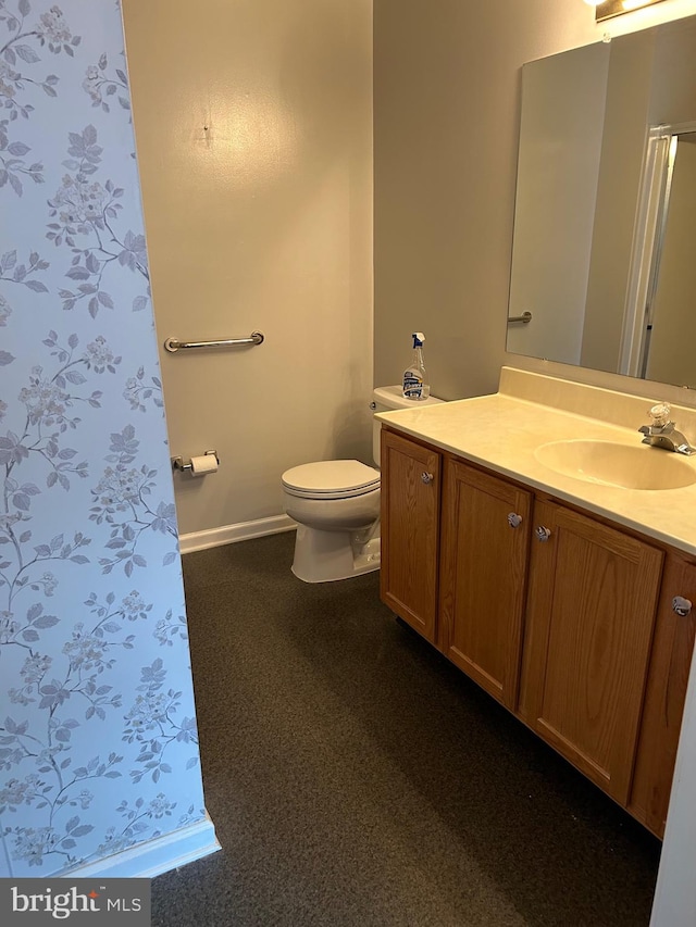 bathroom featuring toilet and vanity