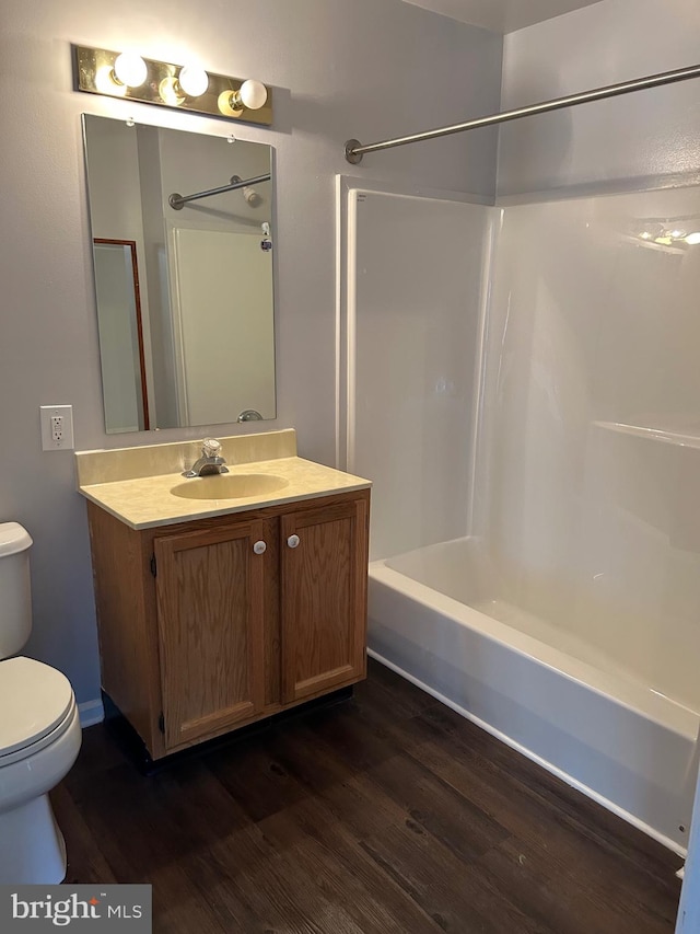 full bathroom with vanity, shower / bathing tub combination, hardwood / wood-style floors, and toilet