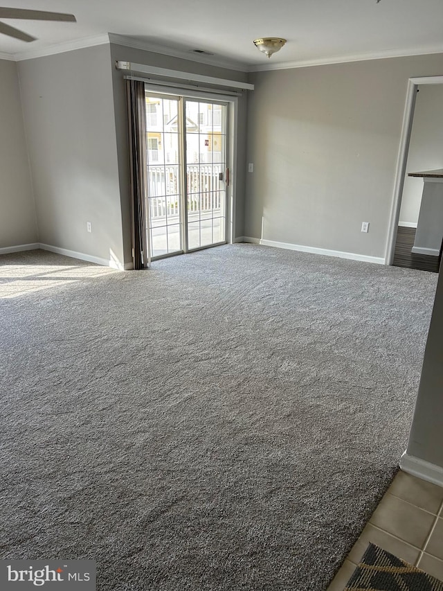 carpeted empty room with crown molding and ceiling fan