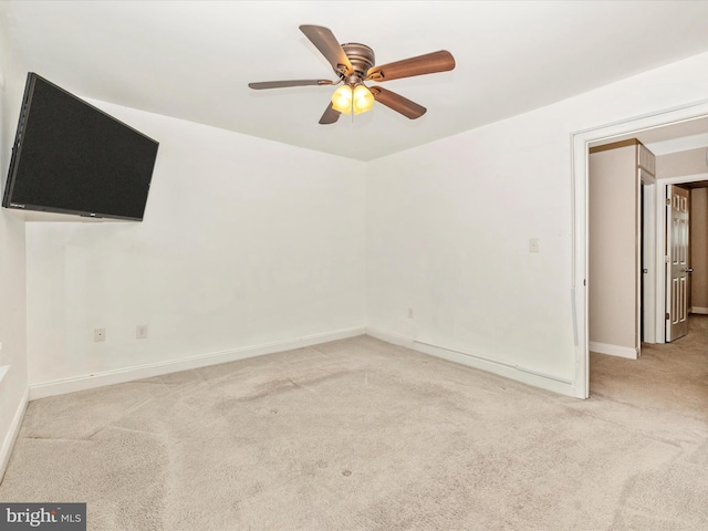 carpeted empty room featuring ceiling fan