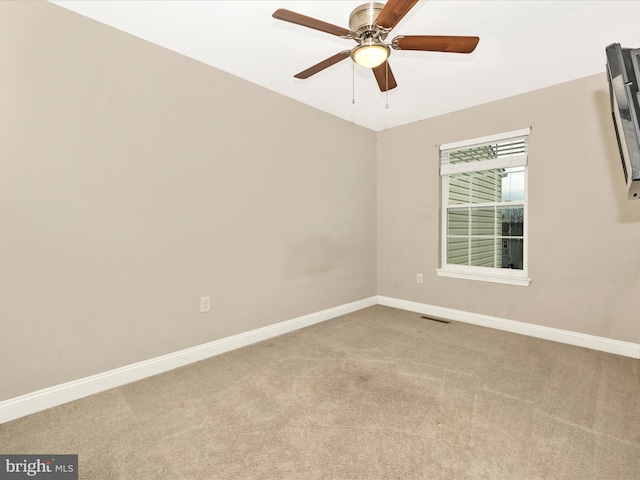 spare room with carpet and ceiling fan