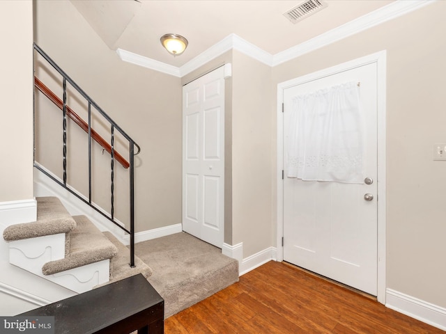 entrance foyer featuring wood-type flooring and ornamental molding