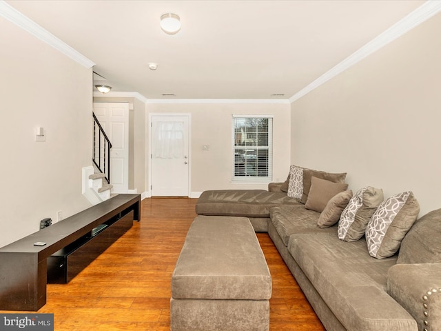 living room featuring hardwood / wood-style flooring and ornamental molding