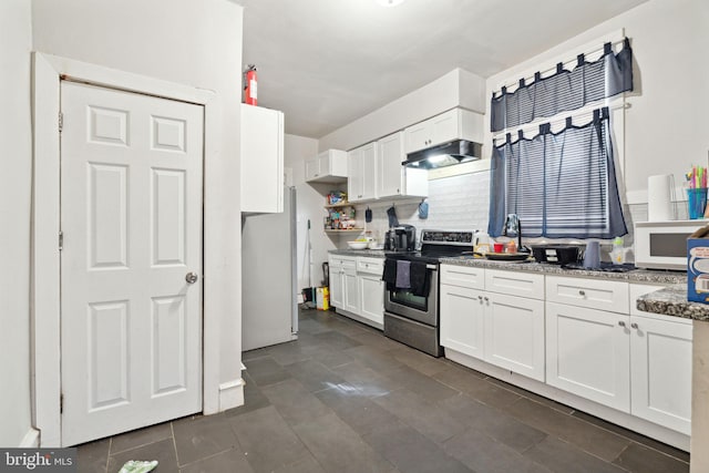 kitchen with light stone countertops, under cabinet range hood, white appliances, and white cabinets