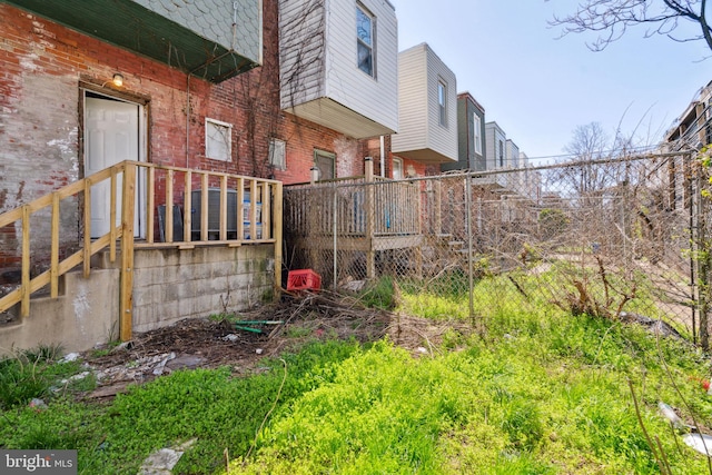view of side of home with fence and brick siding