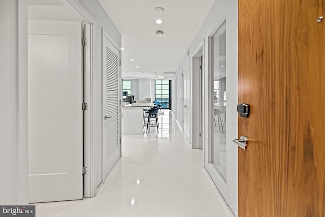 corridor featuring light tile patterned flooring and recessed lighting