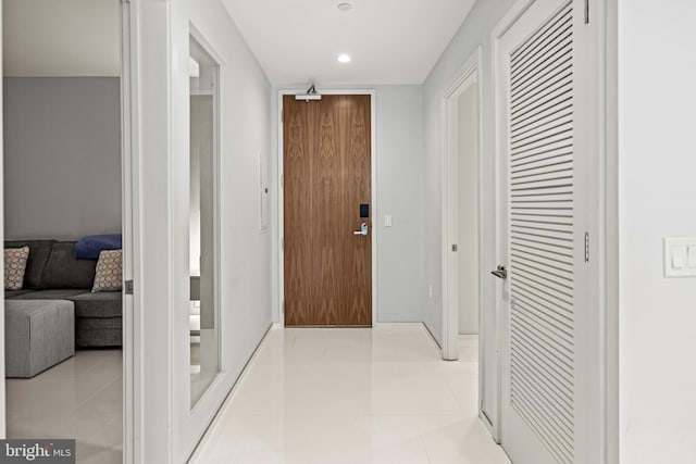 hallway featuring recessed lighting and light tile patterned floors