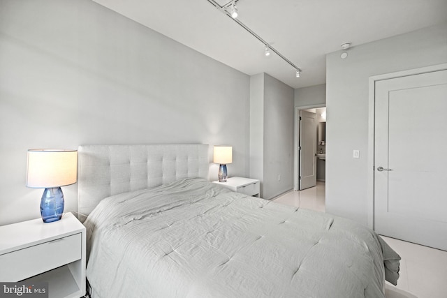 bedroom featuring rail lighting